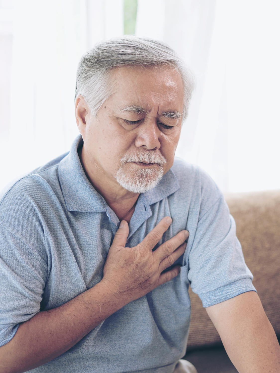 man at home with heart pain