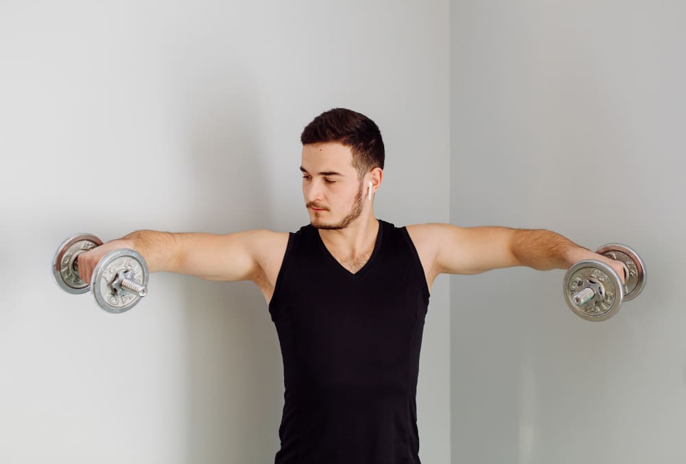 man with arms up training